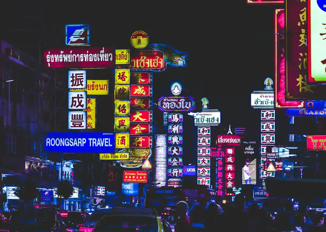 Yaowarat nightlife with neon signs, tuk-tuks, and rainy evening streets photo 3