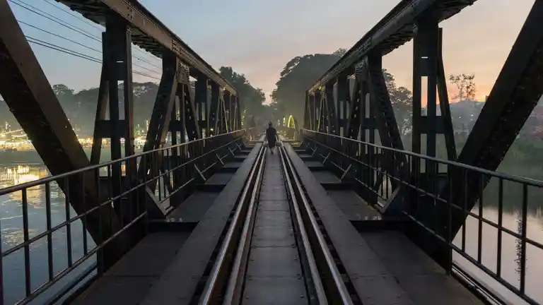 Bridge over the River Kwai railway tracks at dusk