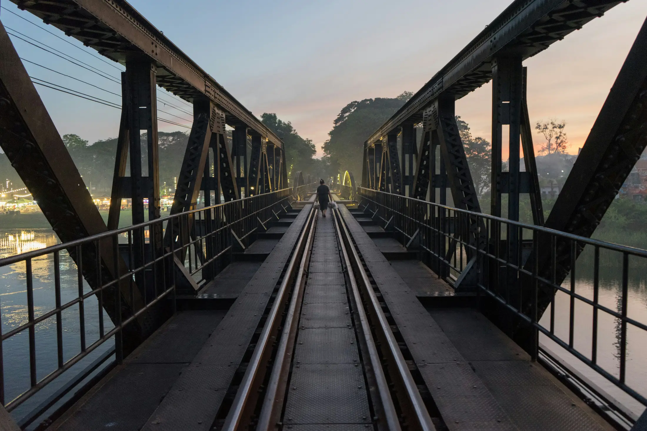 Bridge over the River Kwai railway tracks at dusk in Kanchanaburi