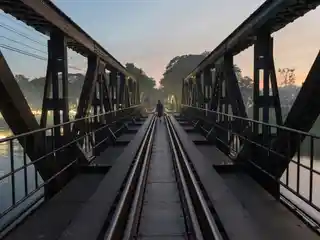 Bridge over the River Kwai railway tracks at dusk in Kanchanaburi