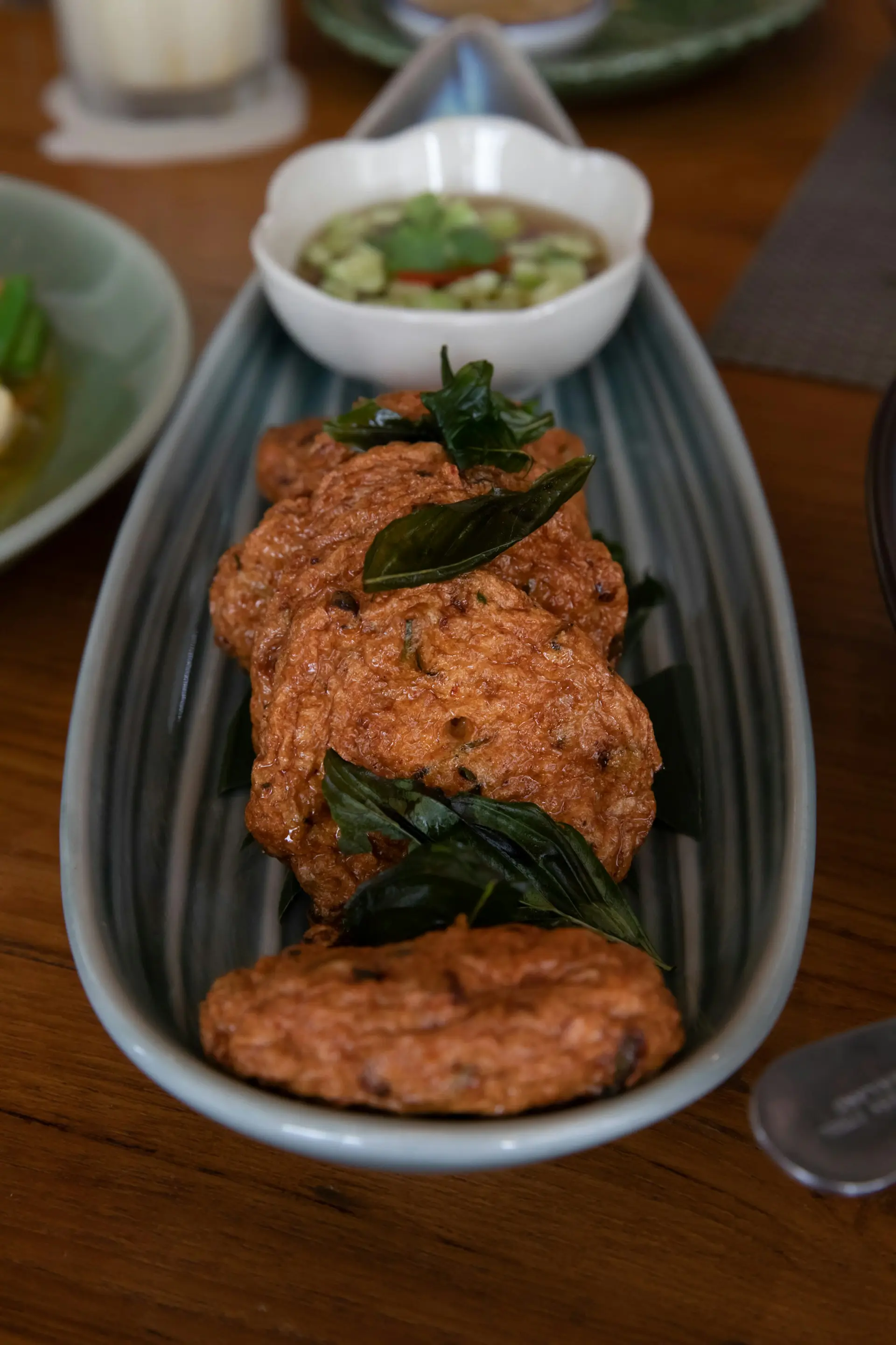 Crispy Thai fish cakes served as a polished restaurant dish