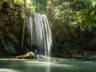 Visitors swimming below Erawan Falls in Kanchanaburi