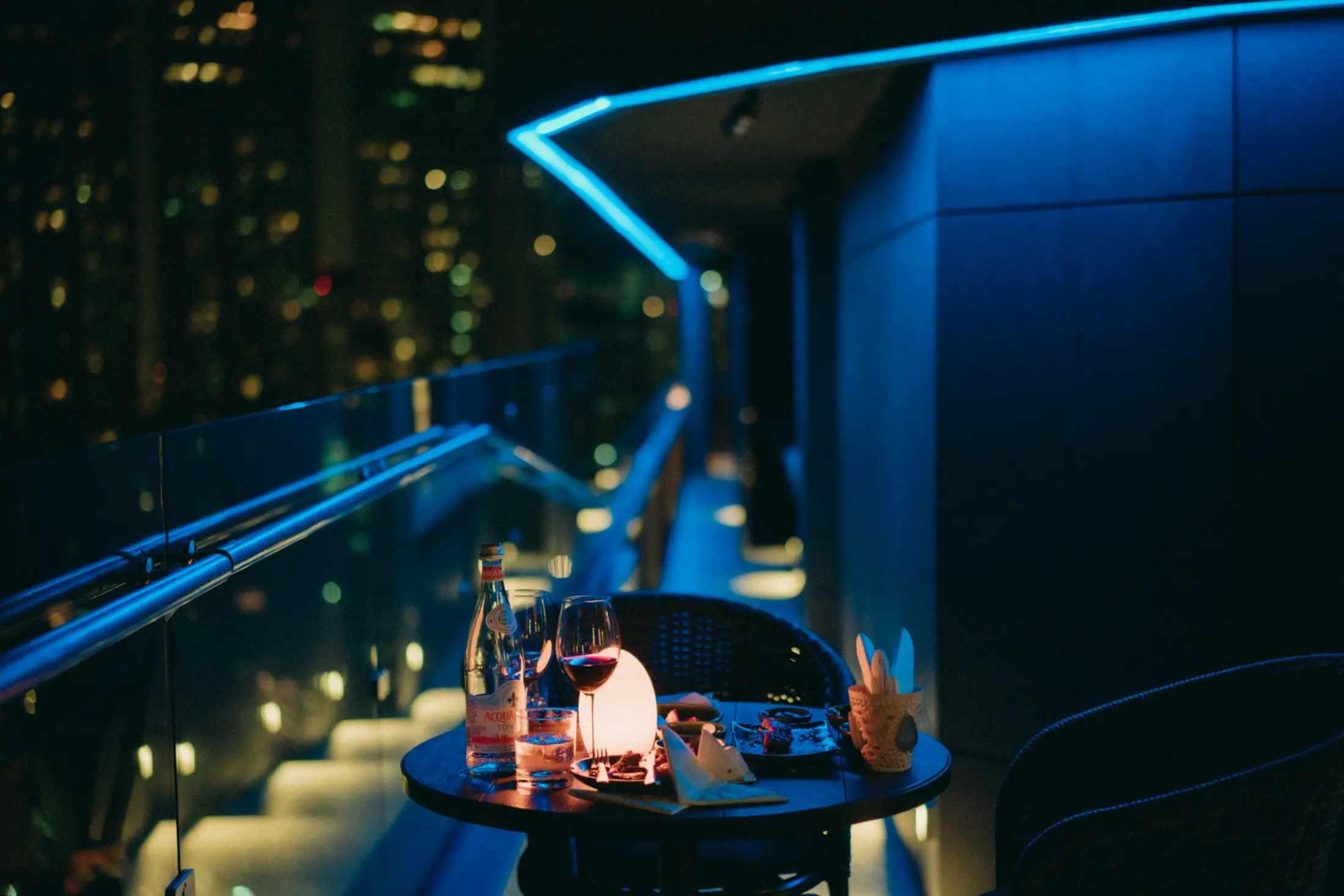 Rooftop cocktail table with blue neon lights in Bangkok