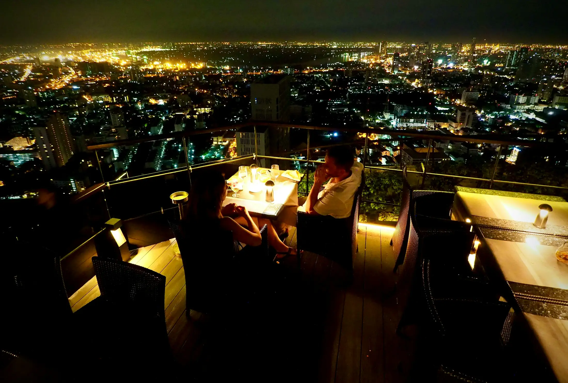 Rooftop dining with a Bangkok skyline view at night