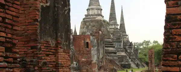 Wat Phra Si Sanphet chedis seen through brick ruins in Ayutthaya