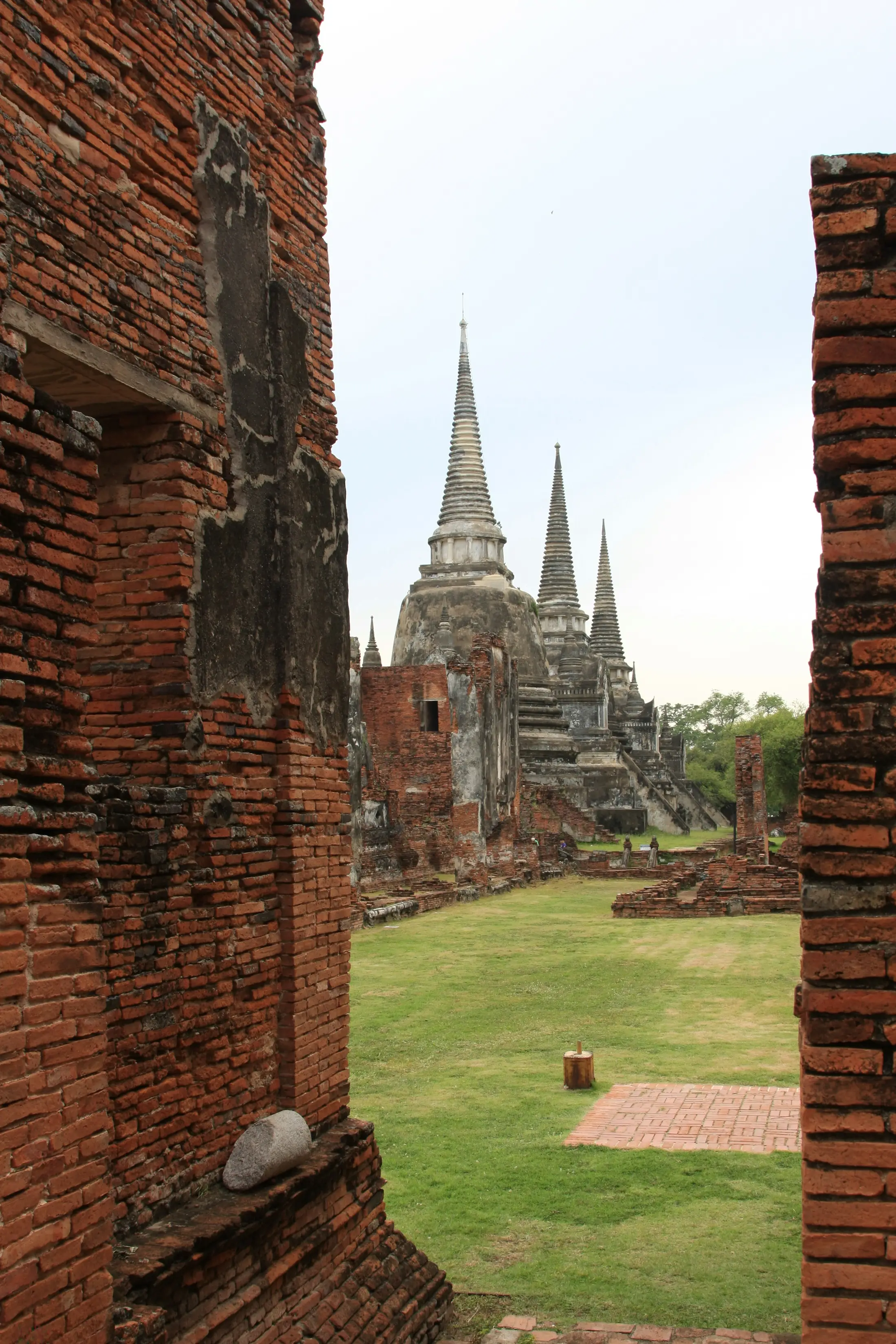 Wat Phra Si Sanphet chedis seen through brick ruins in Ayutthaya