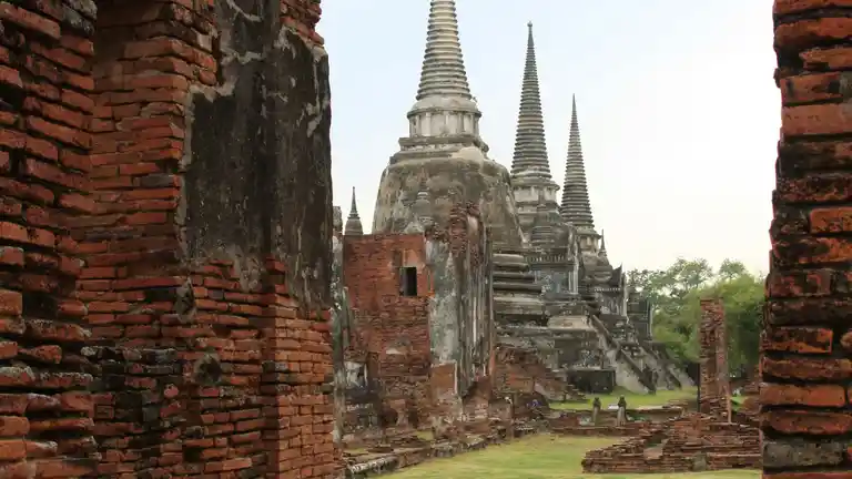 Wat Phra Si Sanphet chedis seen through brick ruins in Ayutthaya